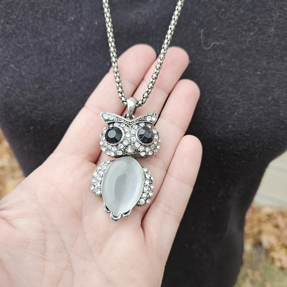 long silver tone chain necklace with articulated owl pendant
